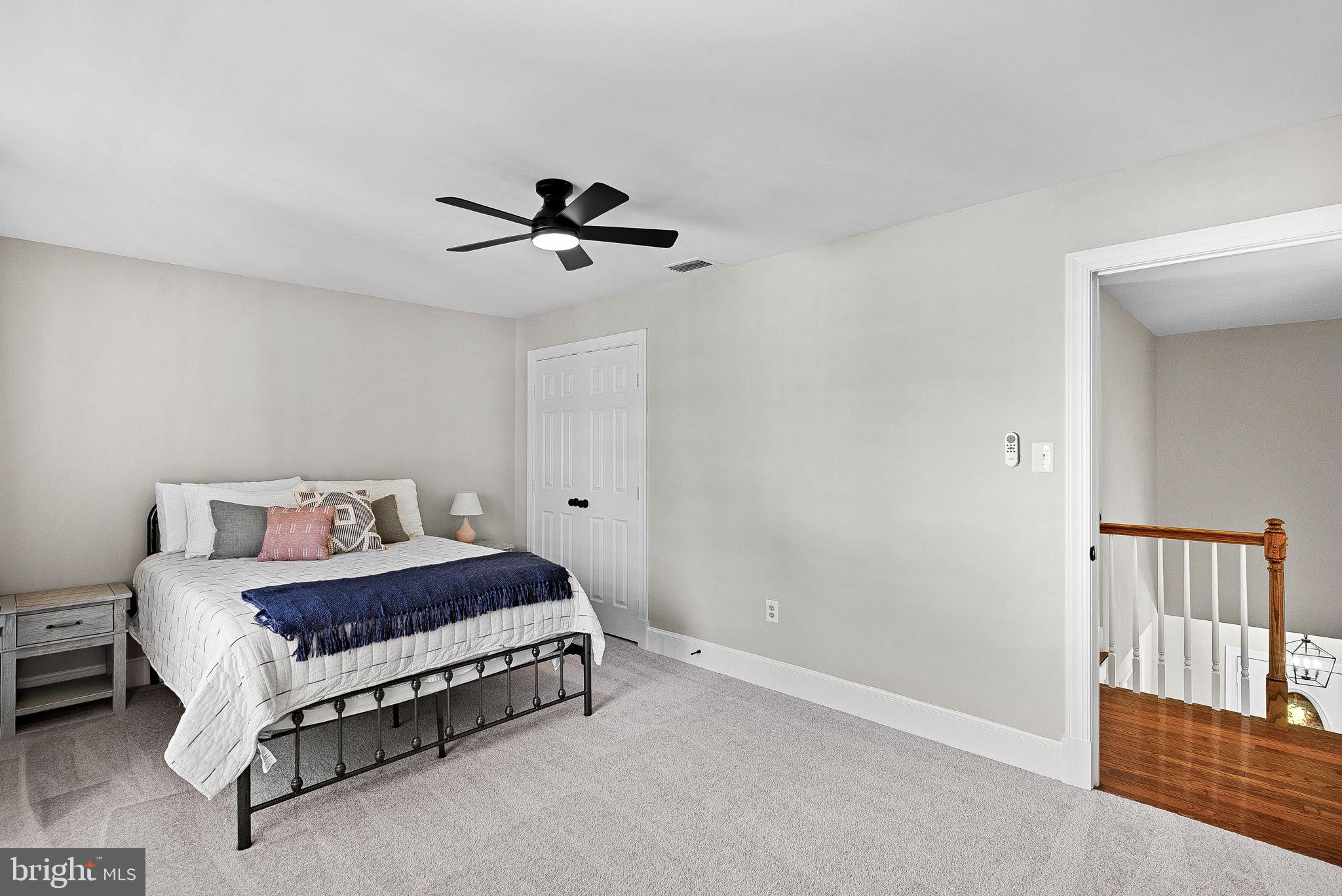 9440 Flowerden Lane Manassas, VA 20110 - Photo 44 of 66 a bedroom with a bed and a chandelier