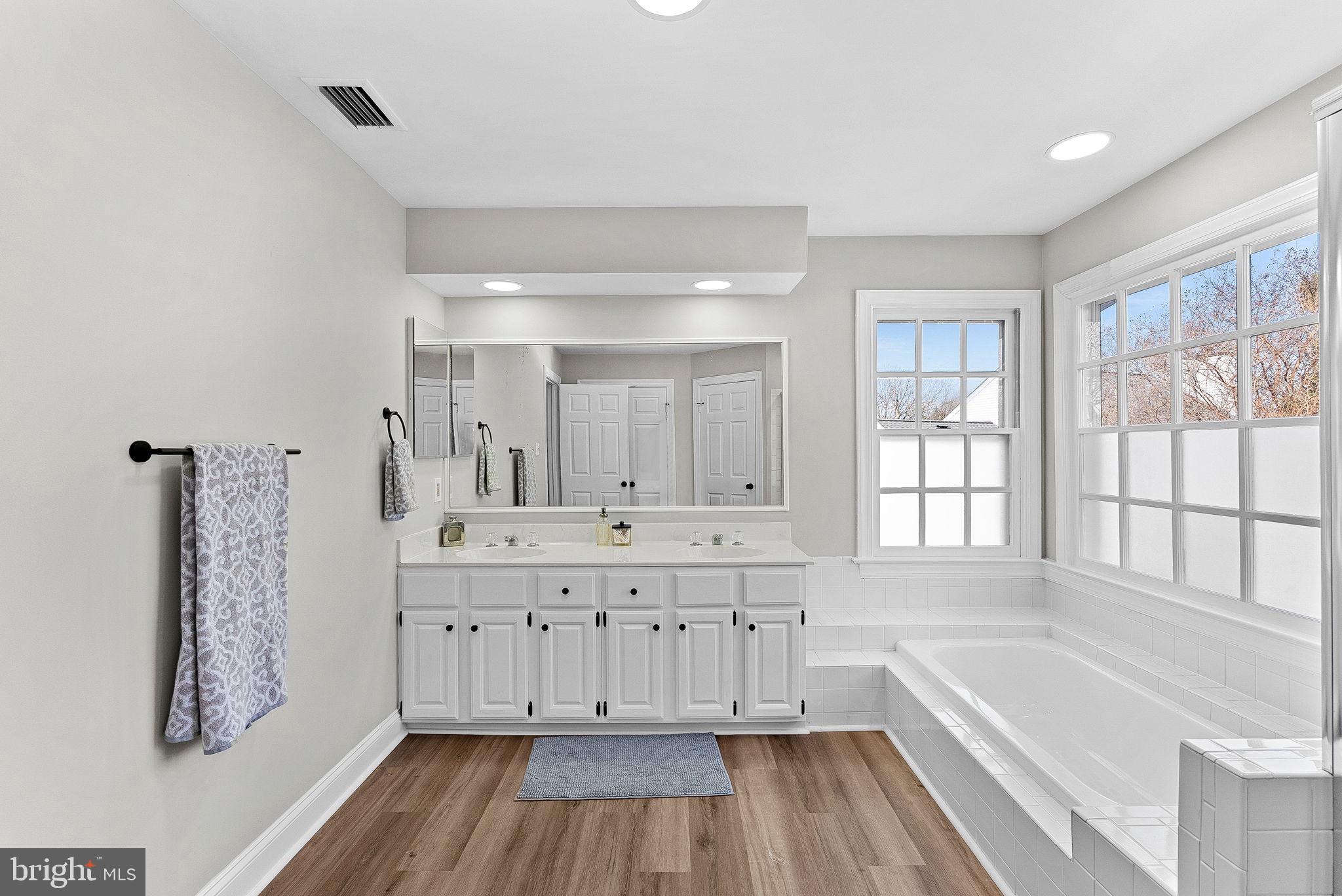 9440 Flowerden Lane Manassas, VA 20110 - Photo 46 of 66 a bathroom with a tub sink and a window