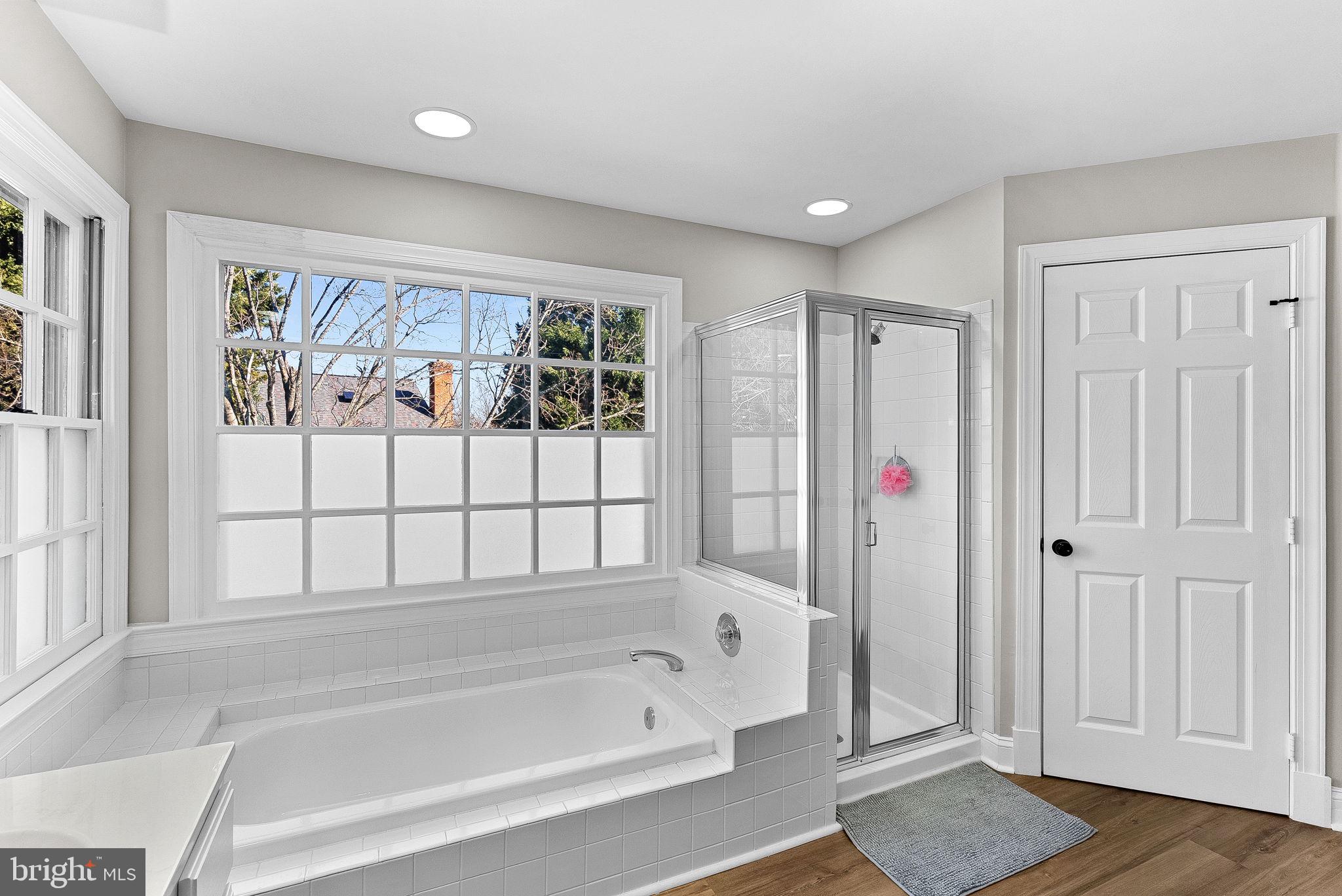 9440 Flowerden Lane Manassas, VA 20110 - Photo 47 of 66 a bathroom with a bathtub and a shower