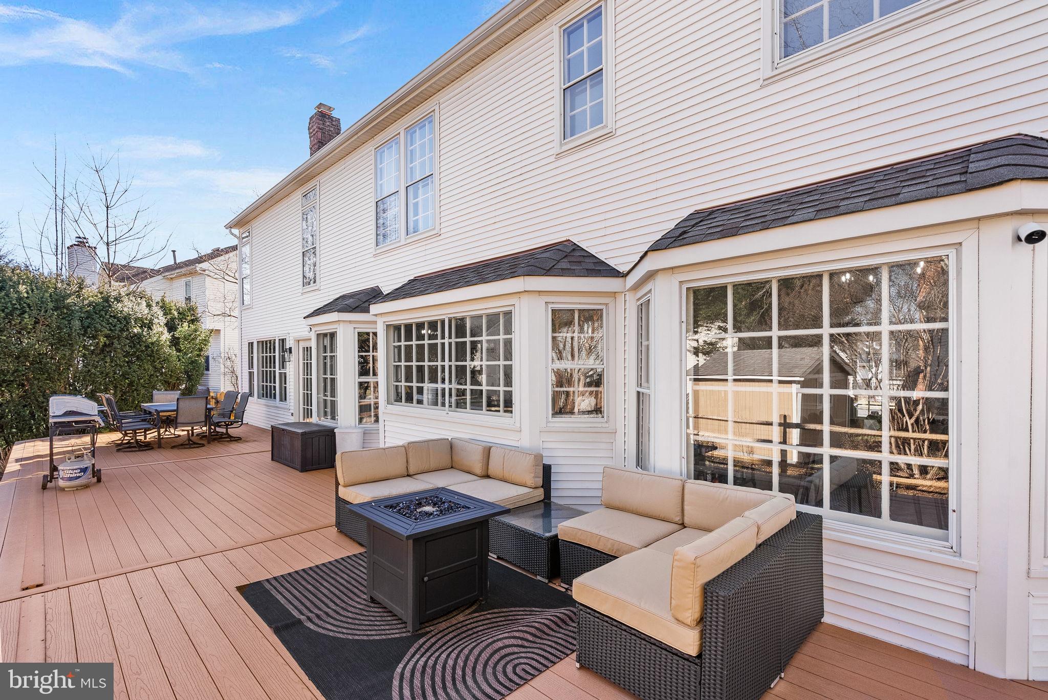 9440 Flowerden Lane Manassas, VA 20110 - Photo 60 of 66 a view of a patio with couches and a dining table and chairs with wooden floor