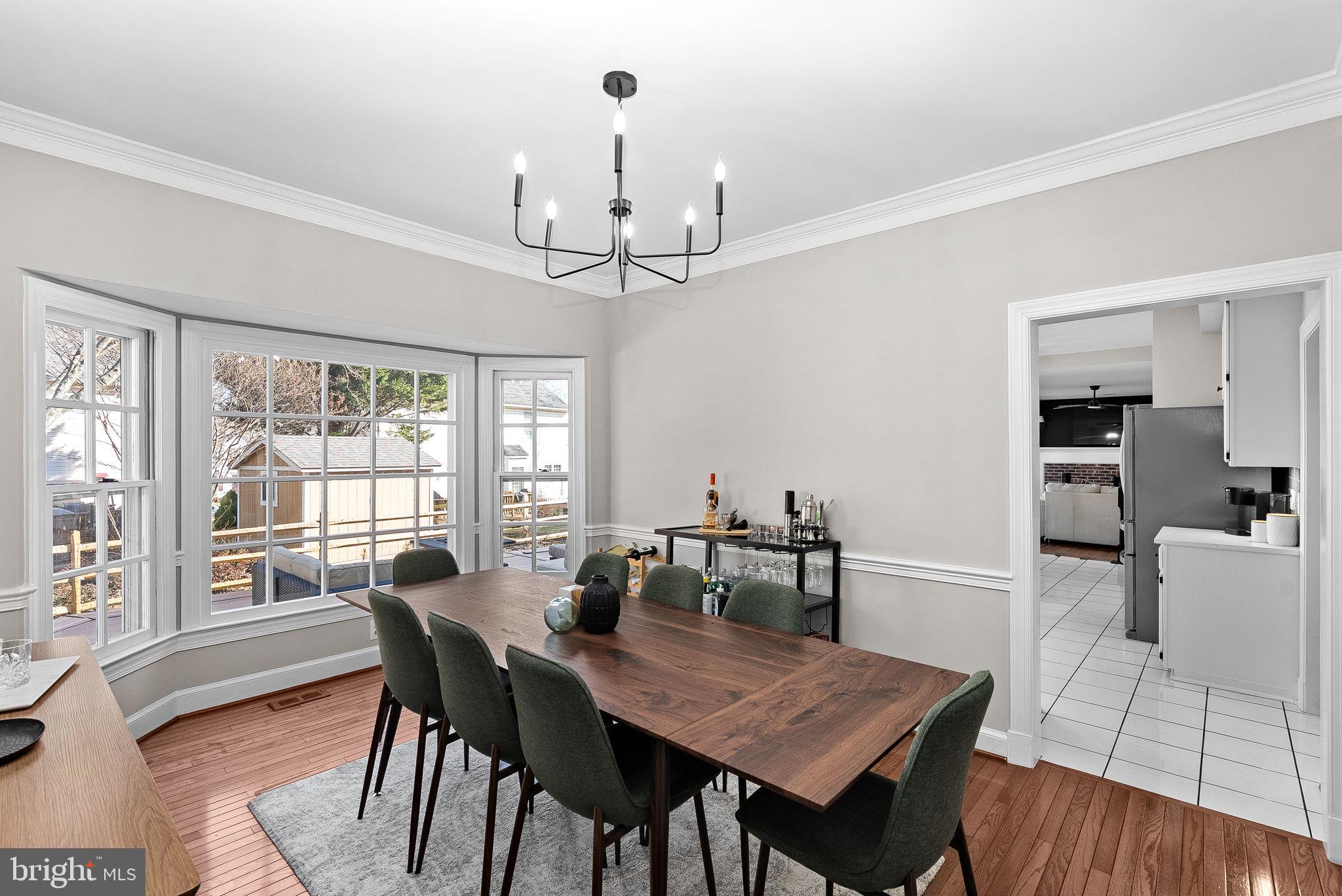 9440 Flowerden Lane Manassas, VA 20110 - Photo 7 of 66 a view of a dining room with furniture window and wooden floor