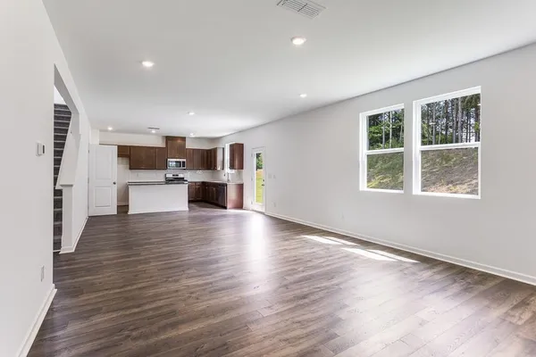 a large kitchen with stainless steel appliances and a sink