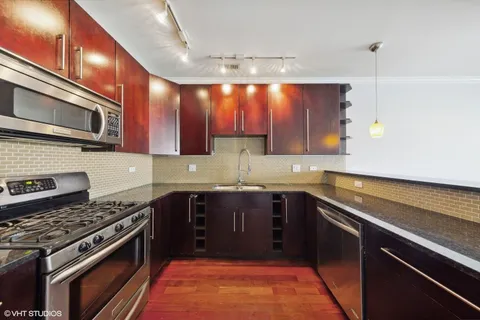 a kitchen with a sink stove and microwave