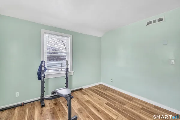 a view of a room with wooden floor and chair