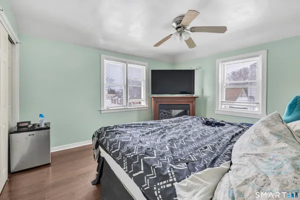 a bedroom with a bed dresser and a window