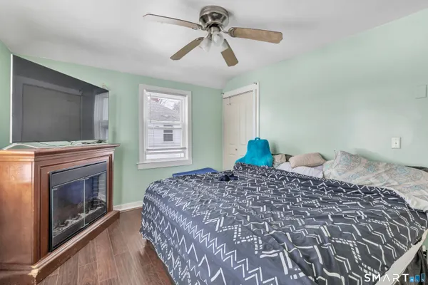 a bedroom with a bed and a fireplace