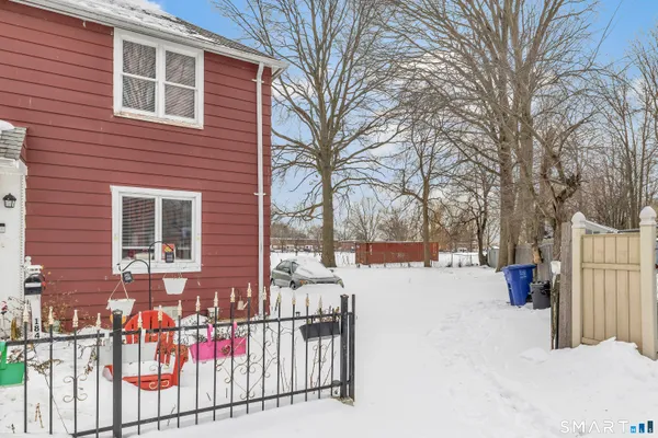 a view of a house with a yard covered in snow