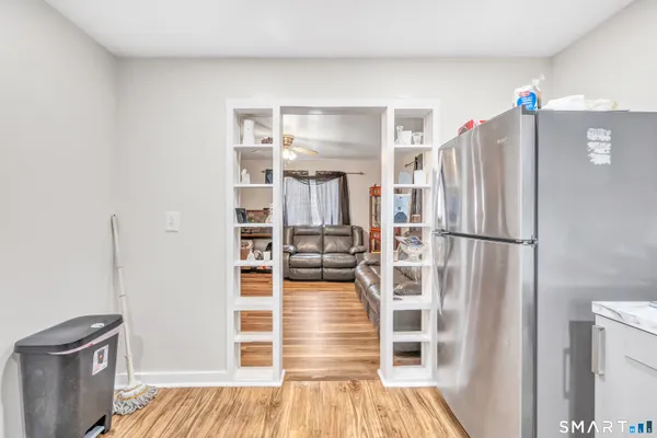 a kitchen with stainless steel appliances granite countertop a refrigerator and a stove top oven