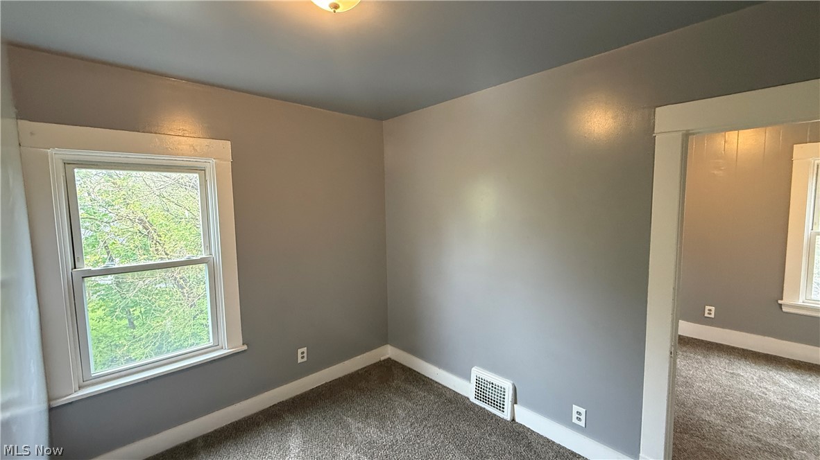 1187 Addison Road, Unit 4 Cleveland, OH 44103 - Photo 8 of 15 Room featuring gray wall paint, white trim, and a window with natural light
