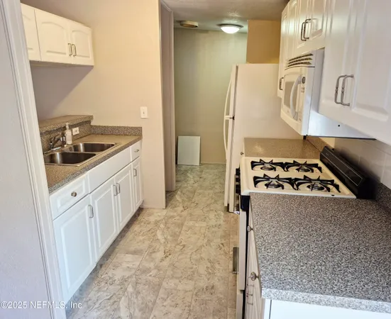 a kitchen with a stove and a refrigerator