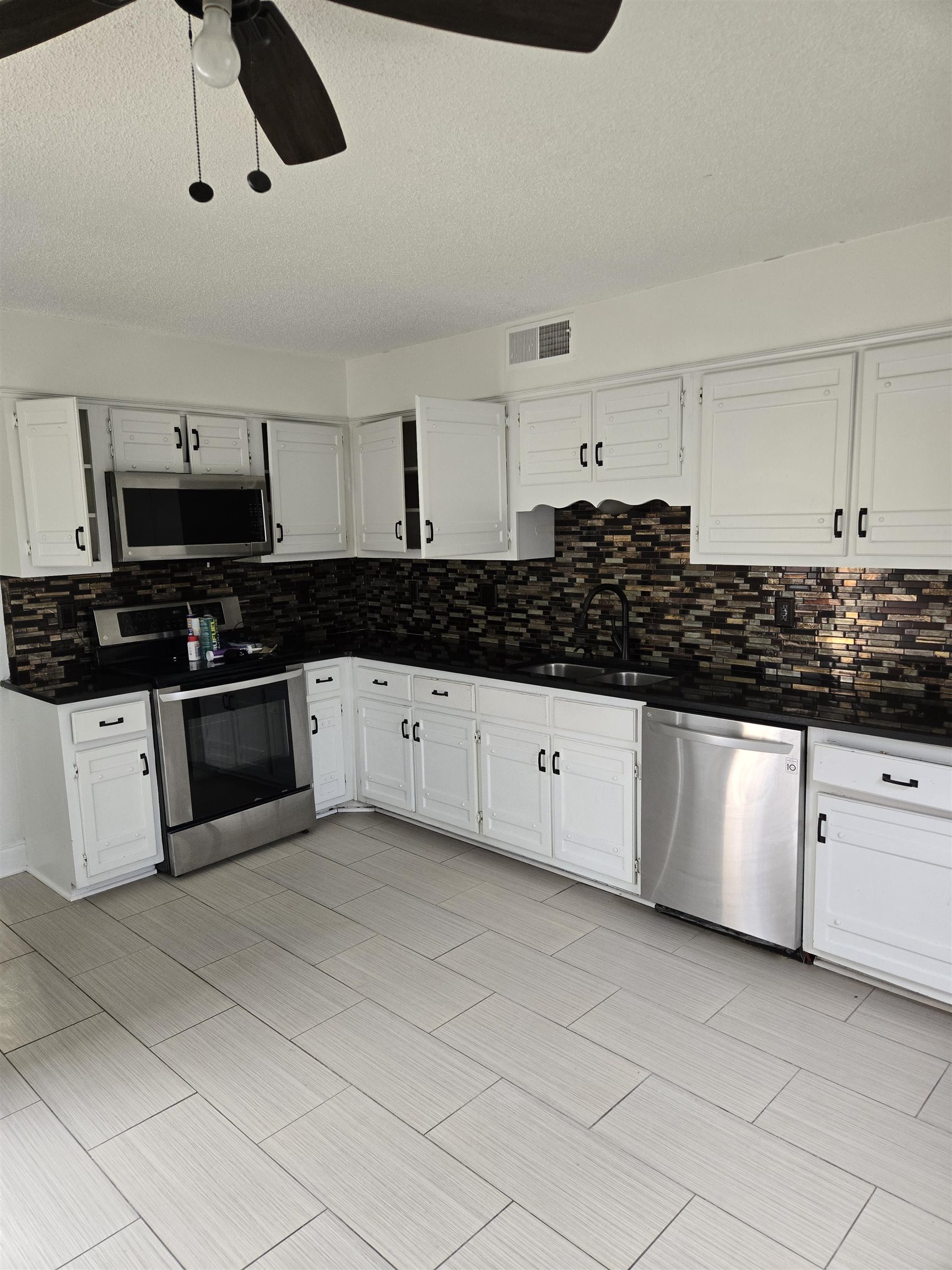 3856 Innsbrook Drive Memphis, TN 38115 - Photo 2 of 11 a kitchen with stainless steel appliances granite countertop a sink and cabinets
