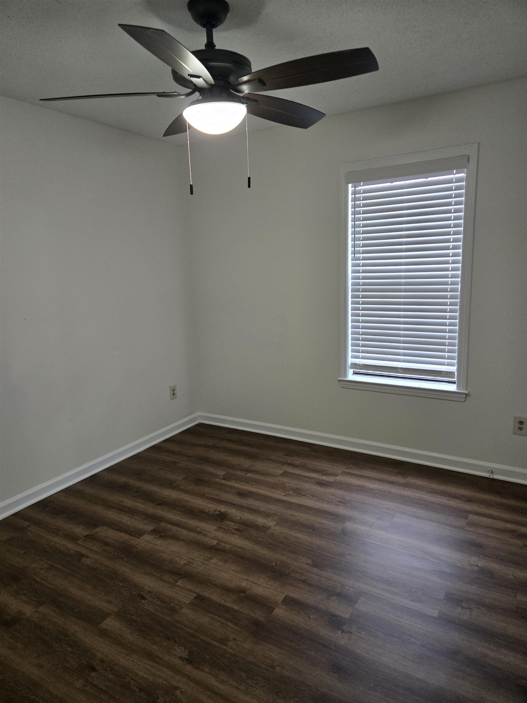 3856 Innsbrook Drive Memphis, TN 38115 - Photo 8 of 11 a view of an empty room with wooden floor and a window