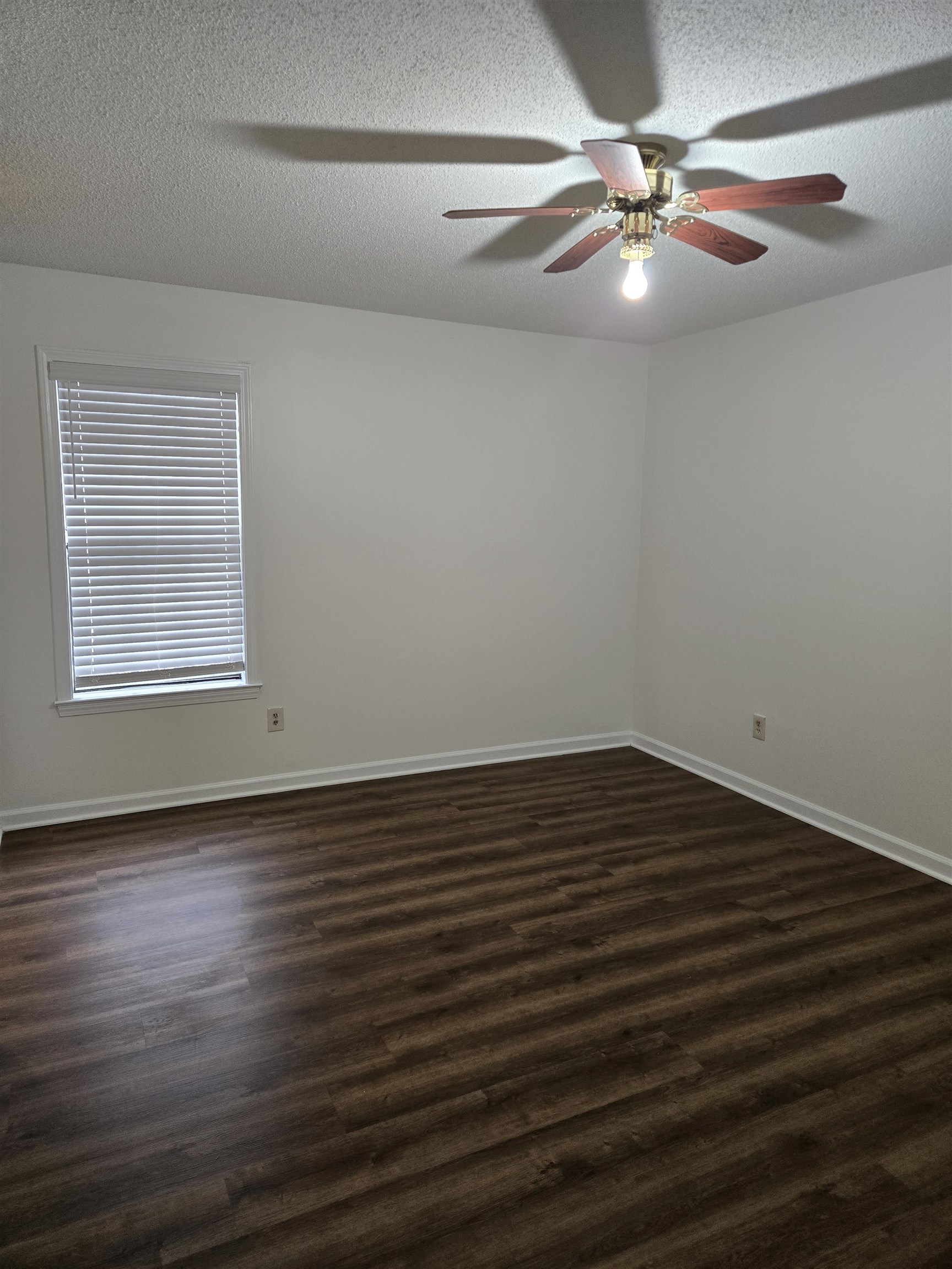 3856 Innsbrook Drive Memphis, TN 38115 - Photo 10 of 11 an empty room with wooden floor chandelier fan and windows
