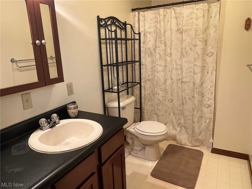 36555 Flat Rock Road Barnesville, OH 43713 - Photo 16 of 35 Bathroom with vanity, toilet, and tile flooring