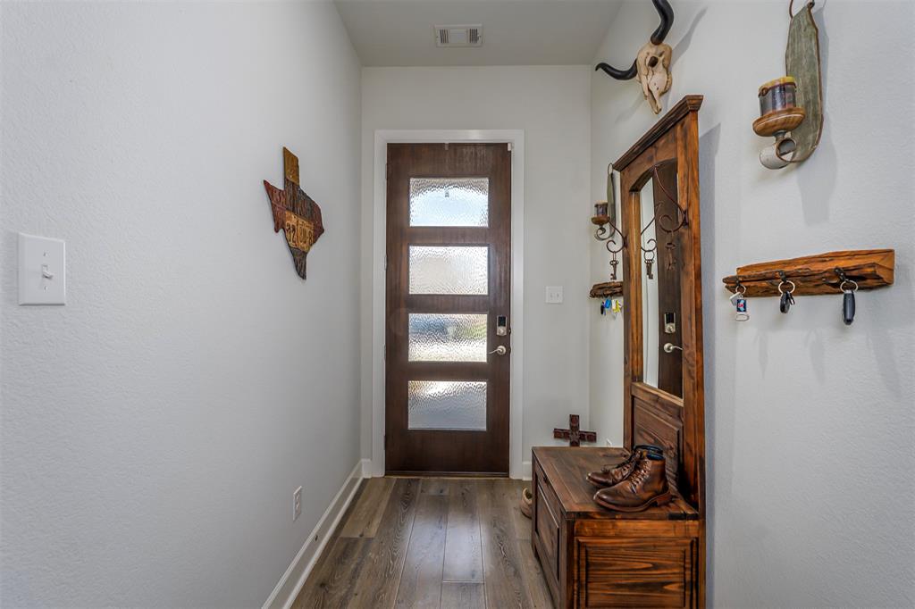 709 Bent Brook Road Oak Point, TX 75068 - Photo 5 of 24 Doorway to outside with wood-type flooring and baseboards