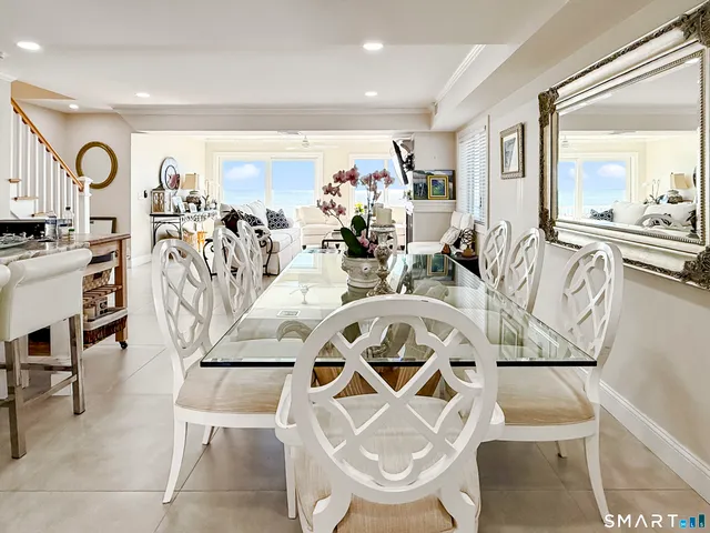 a view of a dining room with furniture a kitchen and chandelier
