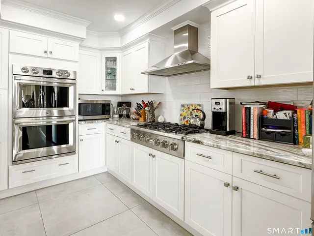 a kitchen with cabinets a sink and stainless steel appliances