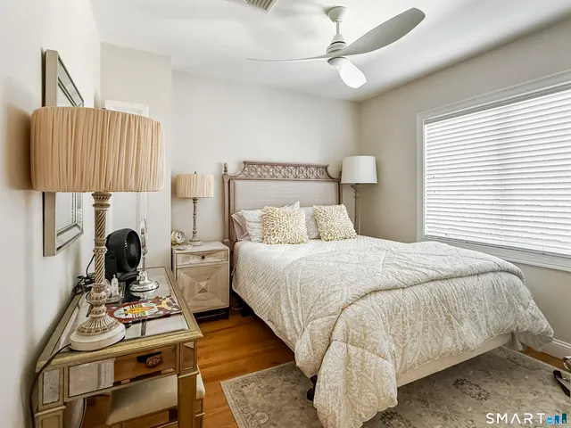 a bedroom with a bed and a table