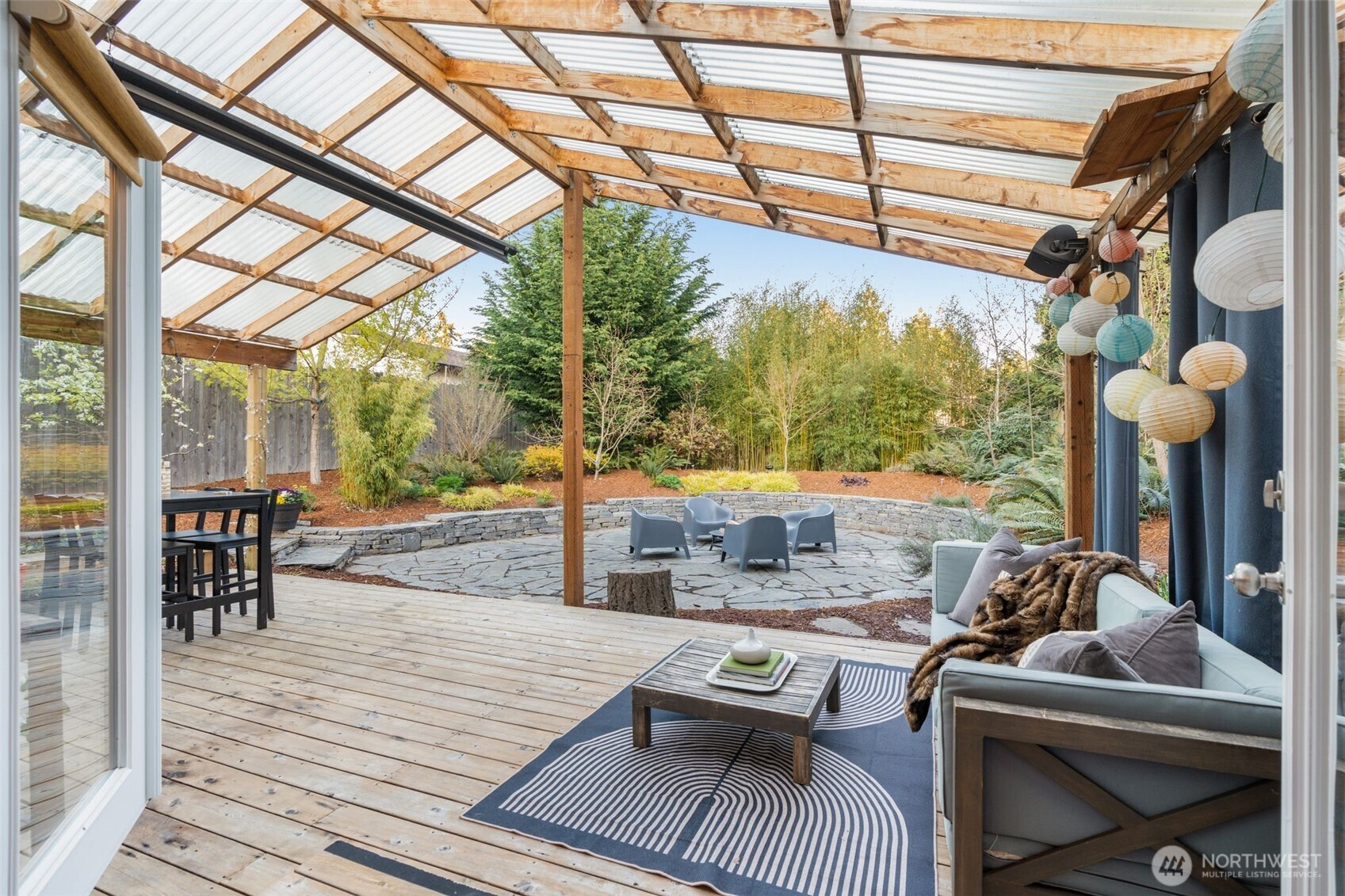 6528 23rd Avenue Southwest Seattle, WA 98106 - Photo 13 of 39 a view of a patio with dining table and chairs with wooden floor