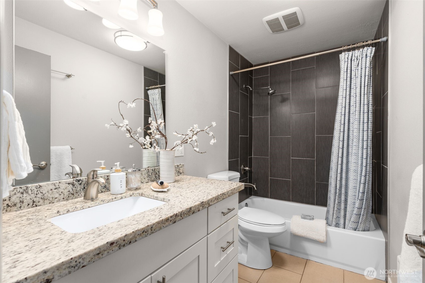 6528 23rd Avenue Southwest Seattle, WA 98106 - Photo 15 of 39 a bathroom with a granite countertop sink toilet and shower