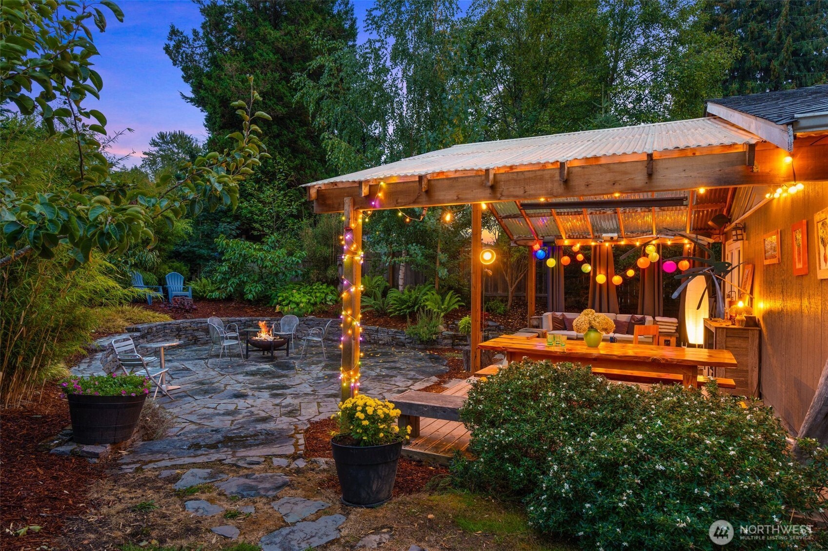 6528 23rd Avenue Southwest Seattle, WA 98106 - Photo 28 of 39 a view of a patio with table and chairs potted plants