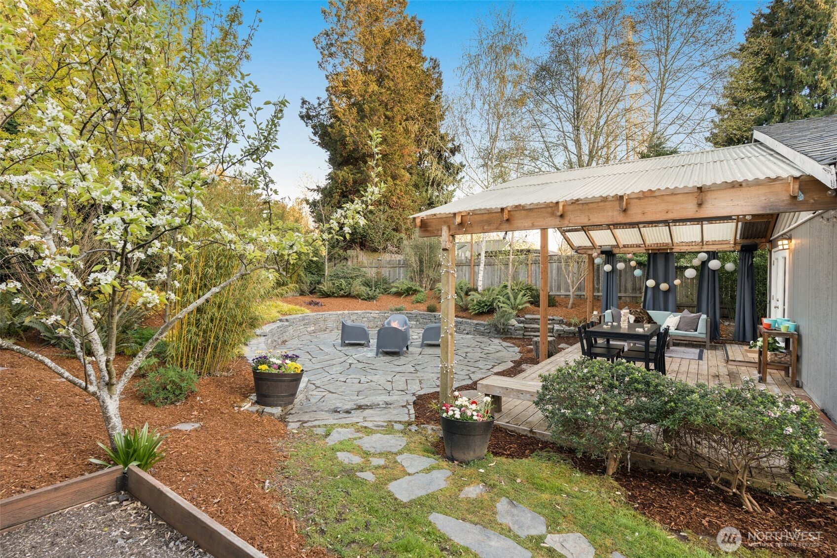 6528 23rd Avenue Southwest Seattle, WA 98106 - Photo 30 of 39 a view of a patio with table and chairs under an umbrella