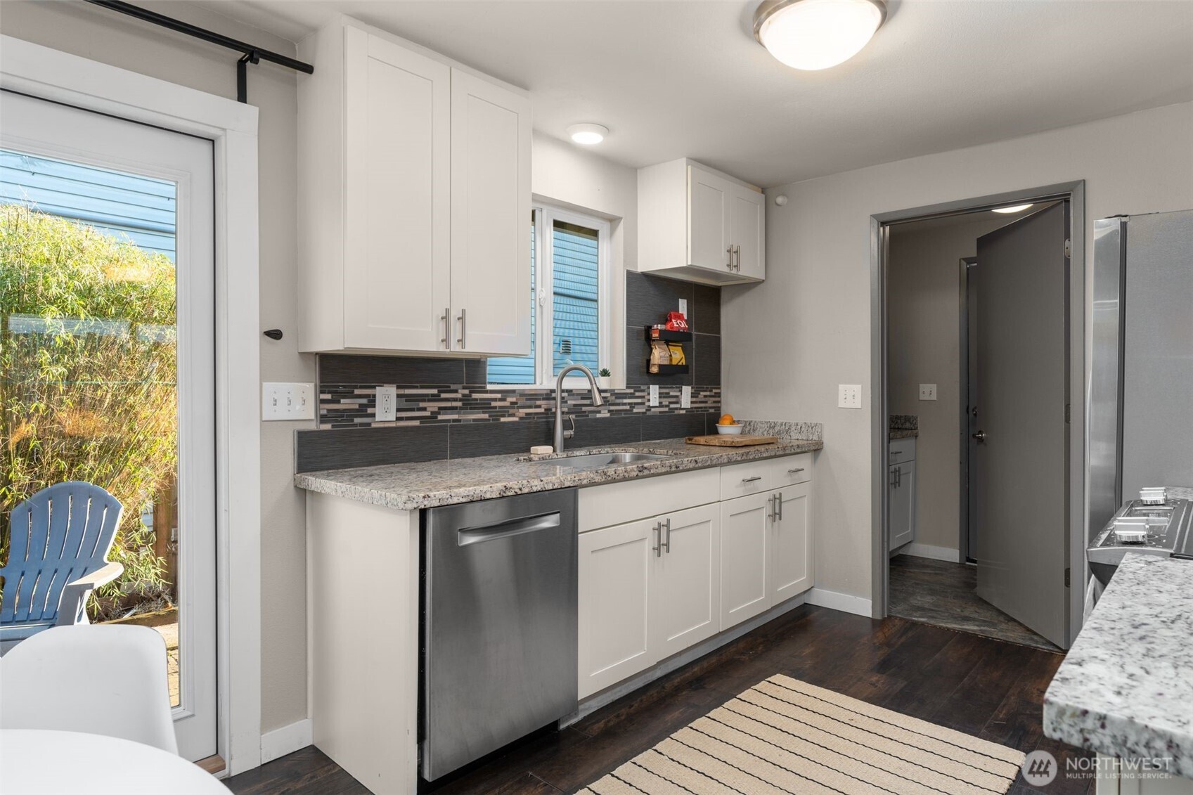 6528 23rd Avenue Southwest Seattle, WA 98106 - Photo 9 of 39 a kitchen with stainless steel appliances granite countertop a stove a sink and a refrigerator