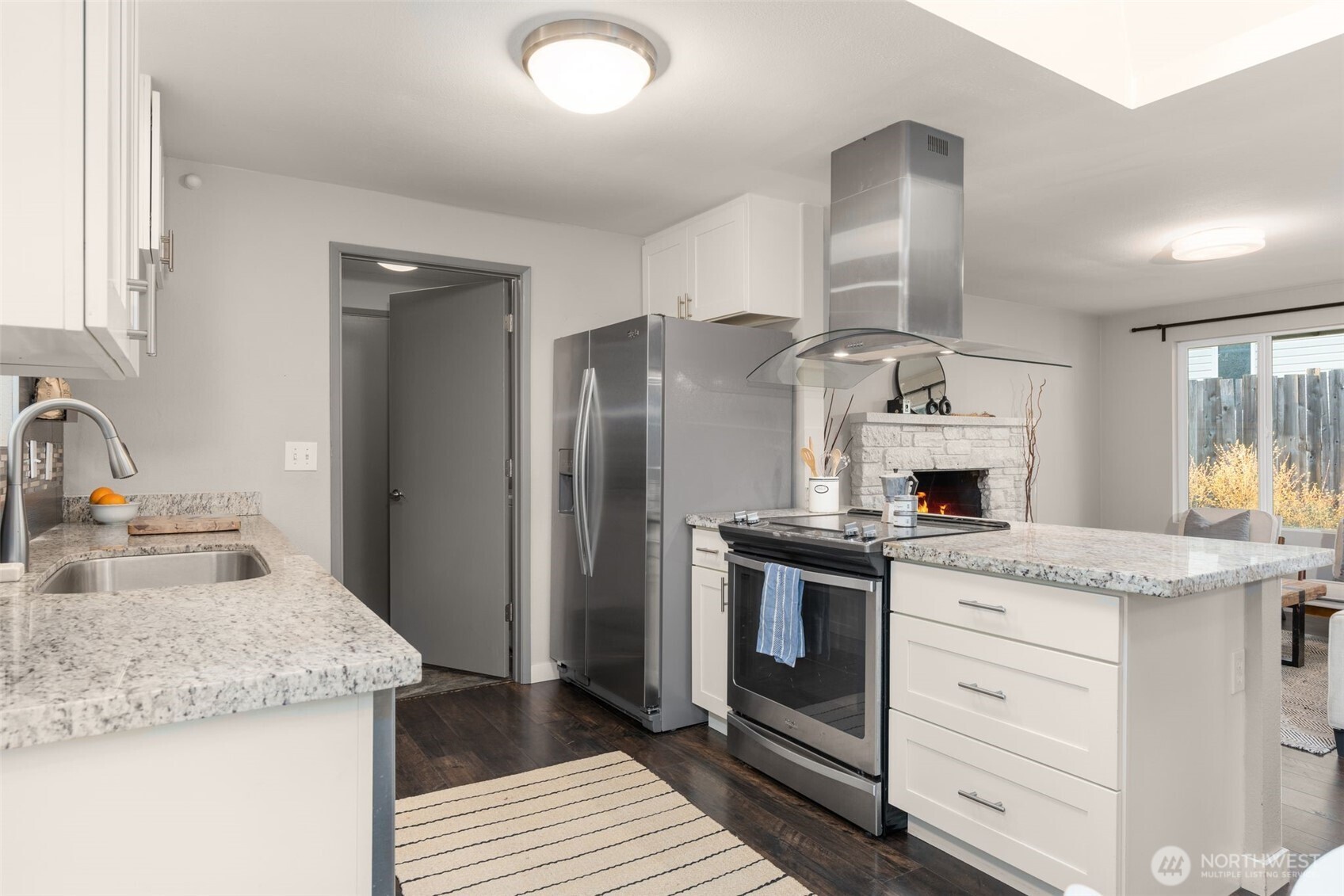 6528 23rd Avenue Southwest Seattle, WA 98106 - Photo 10 of 39 a kitchen with granite countertop a sink stove and refrigerator