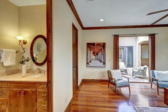 a living room with furniture a window and wooden floor