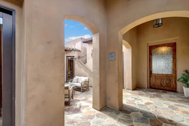 a view of a livingroom with wooden floor and a bedroom