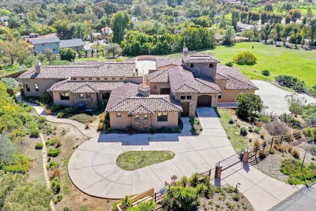 an aerial view of a house with yard swimming pool and outdoor seating