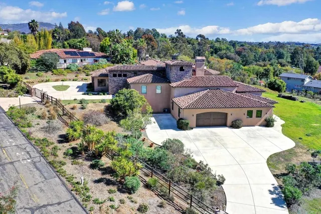 a view of a house with a yard and a large window