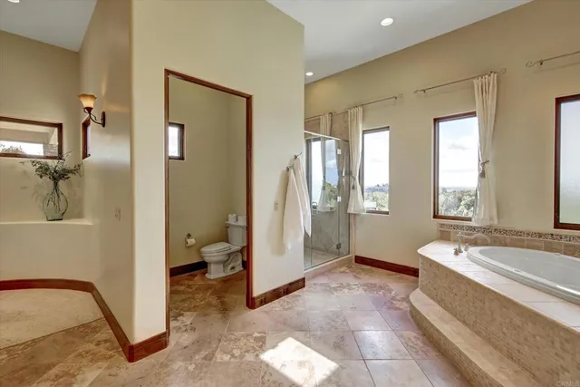 a spacious bathroom with a tub sink and mirror
