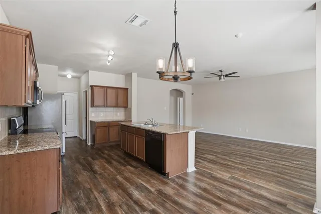 a kitchen with stainless steel appliances a refrigerator and a stove