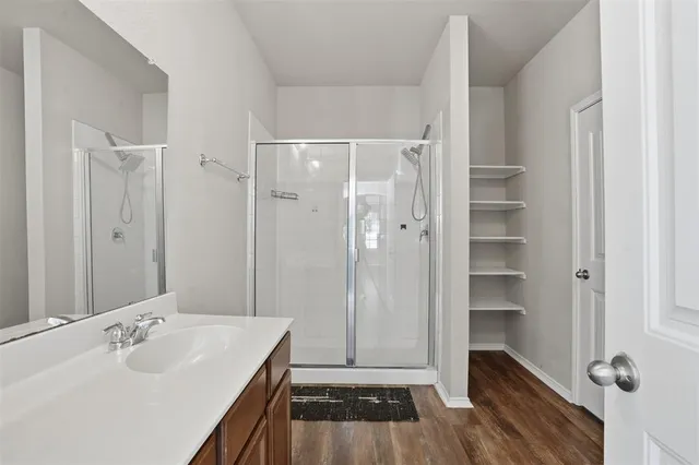 a bathroom with a shower sink and toilet