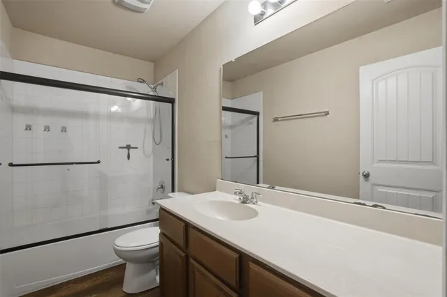 a bathroom with a tub shower vanity and a sink