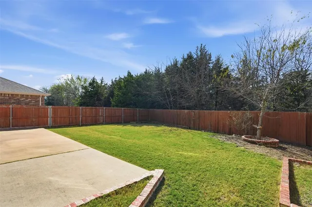 a view of a house with backyard and deck