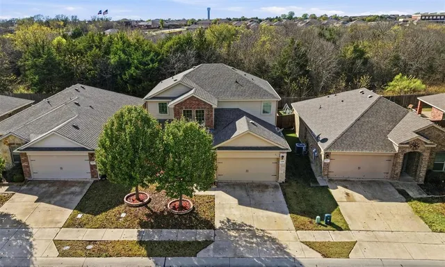 an aerial view of residential houses with outdoor space