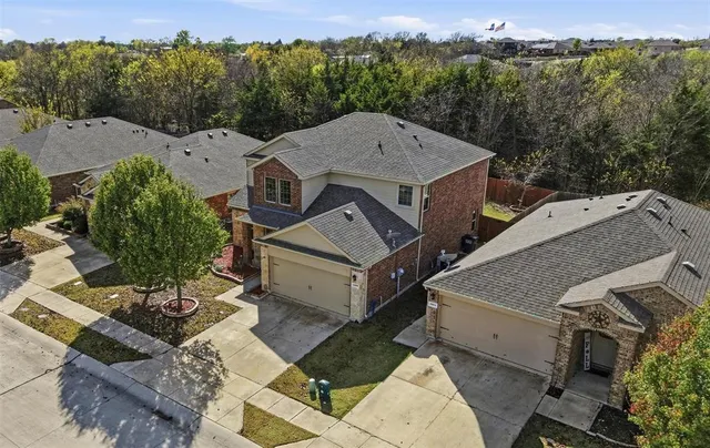 an aerial view of a house with a swimming pool