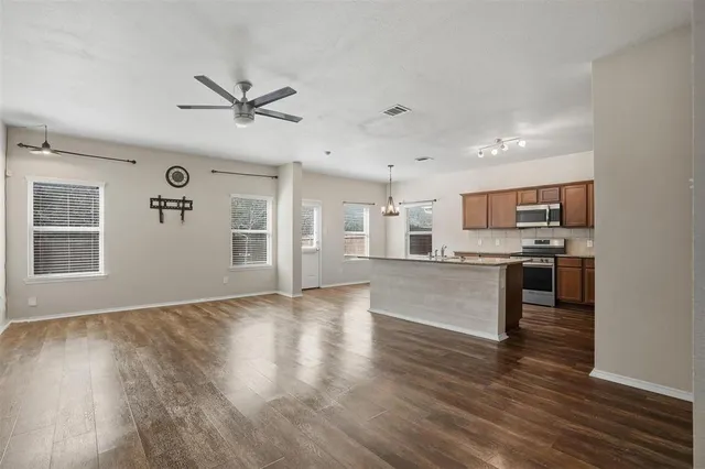 a view of kitchen with wooden floor and electronic appliances