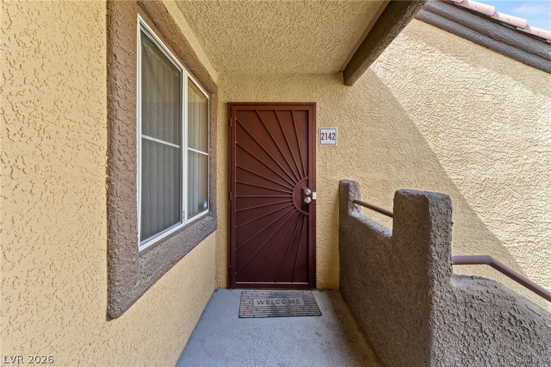 7950 West Flamingo Road, Unit 2142 Las Vegas, NV 89147 - Photo 3 of 24 A welcoming entry features a distinctive sunburst security door, offering both charm and protection.