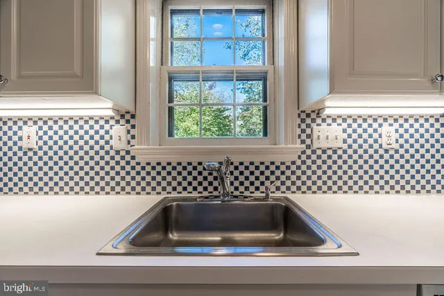 a kitchen that has a sink and a window