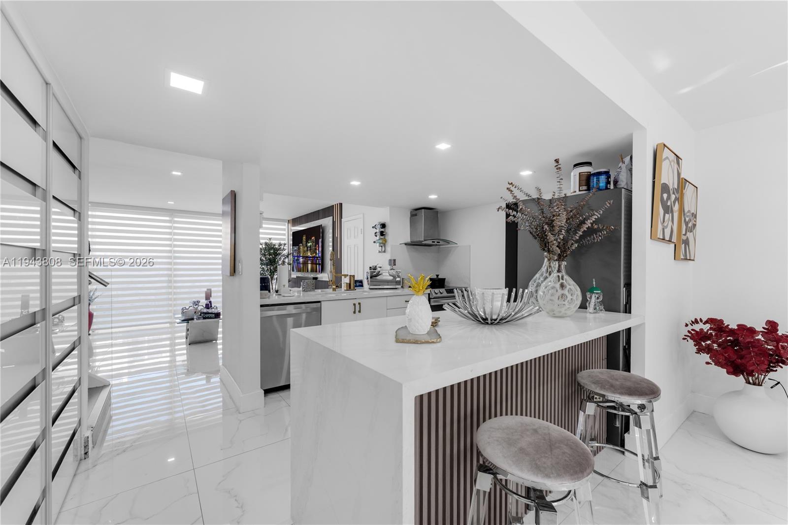 13835 Southwest 84th Street, Unit 503 Miami, FL 33183 - Photo 11 of 32 a kitchen with a sink cabinets and living room