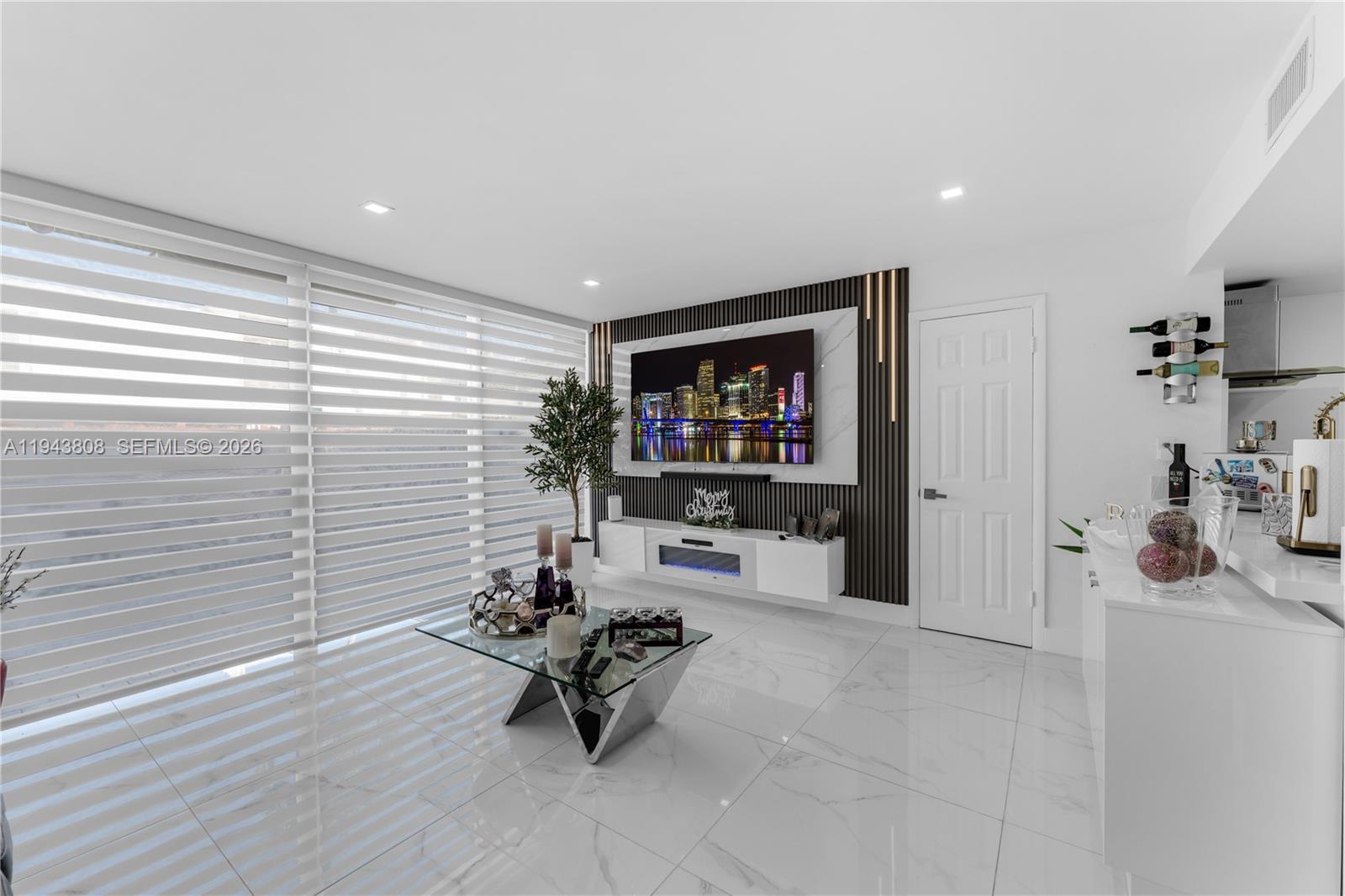 13835 Southwest 84th Street, Unit 503 Miami, FL 33183 - Photo 3 of 32 a living room with furniture and a flat screen tv