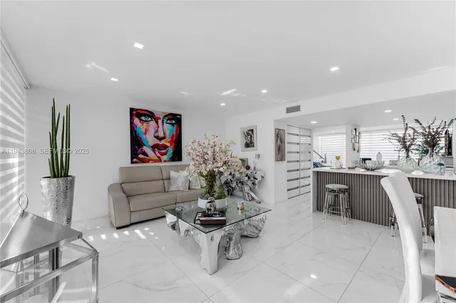 a living room with furniture a dining table and kitchen view