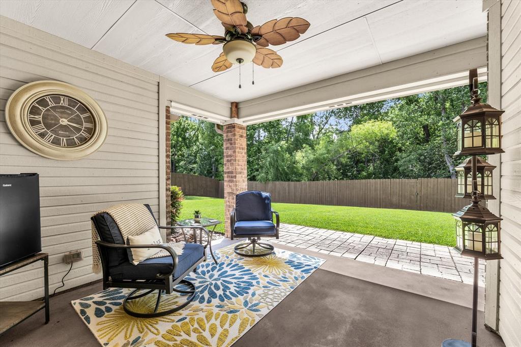 814 Springdale Circle Lorena, TX 76655 - Photo 31 of 37 Covered patio featuring a ceiling fan with leaf-shaped blades, brick-clad columns, and a concrete floor