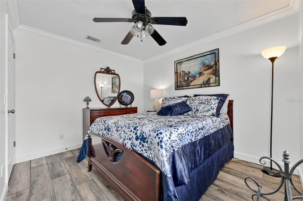 575 Tiberon Cove Road Longwood, FL 32750 - Photo 27 of 56 a bedroom with a bed a ceiling fan and a dresser