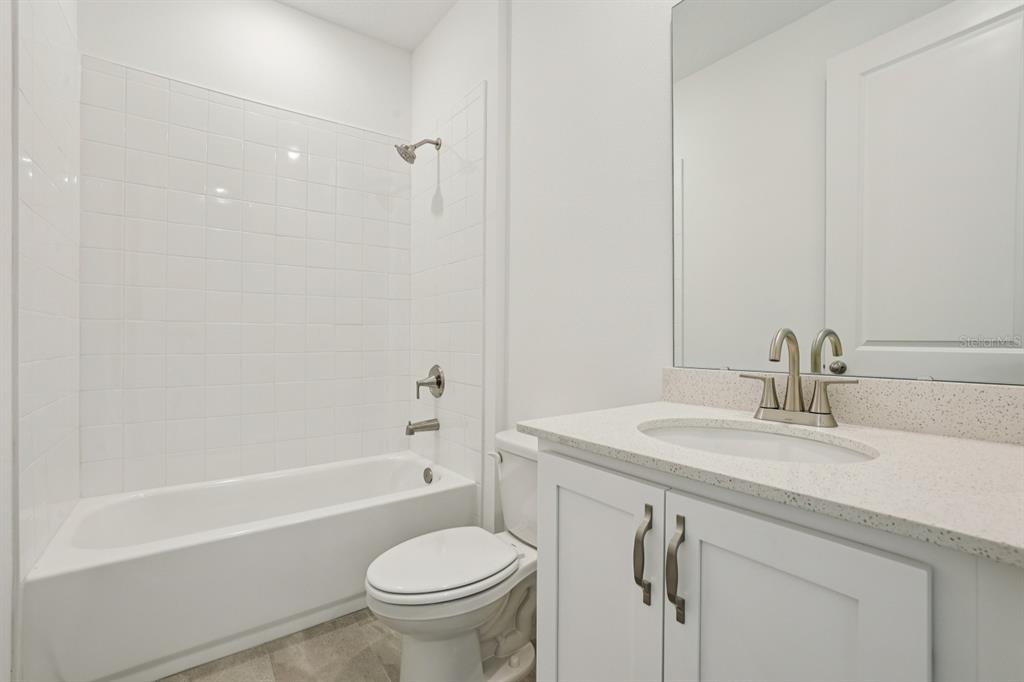 5740 Haystack Drive St. Cloud, FL 34771 - Photo 19 of 39 a bathroom with a sink a toilet and a bathtub