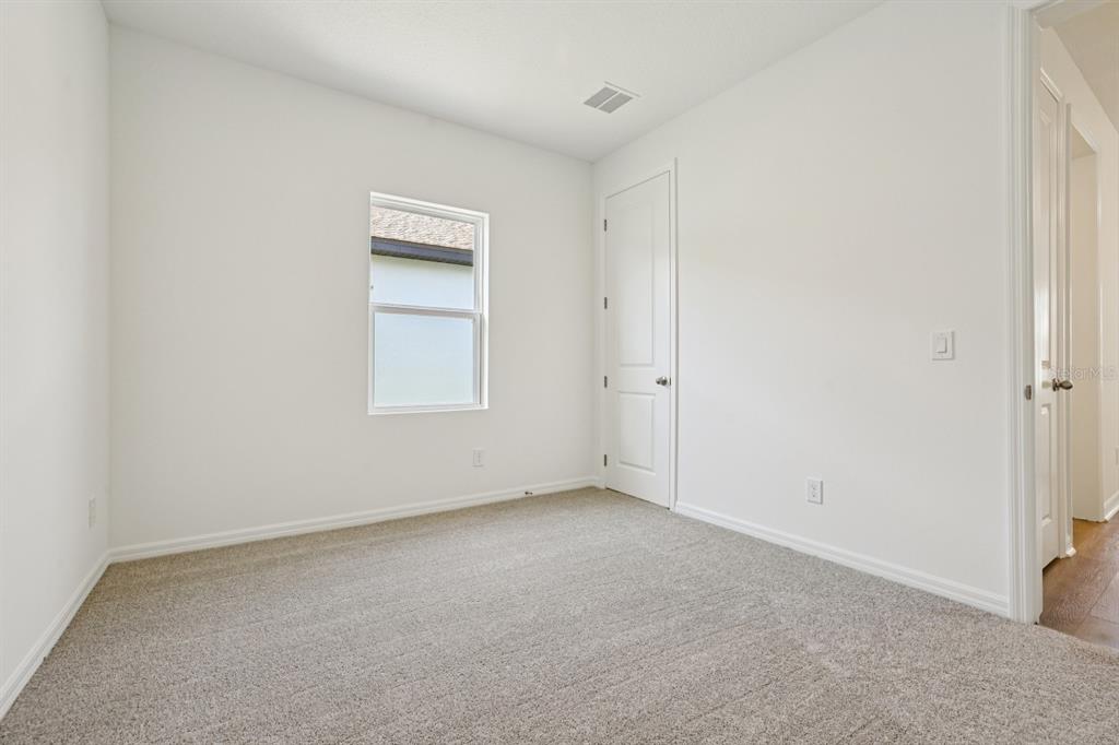 5740 Haystack Drive St. Cloud, FL 34771 - Photo 21 of 39 a view of an empty room with a window