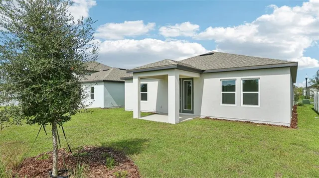 a view of house with backyard